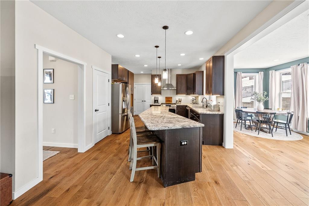 141 Morningstar Drive Belle Vernon, PA 15012 - Photo 13 of 39 a kitchen with stainless steel appliances kitchen island granite countertop wooden floors and white cabinets