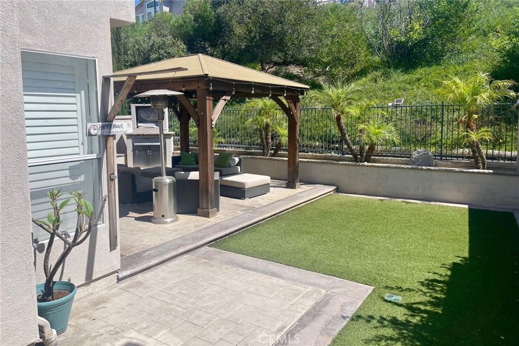 45 Blazewood Lake Forest, CA 92610 - Photo 13 of 13 a view of a patio with table and chairs under an umbrella