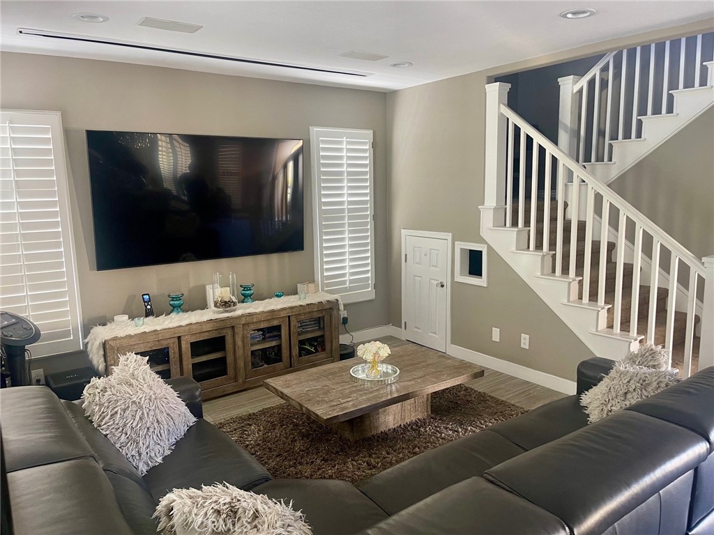 45 Blazewood Lake Forest, CA 92610 - Photo 4 of 13 a living room with couches and a flat screen tv