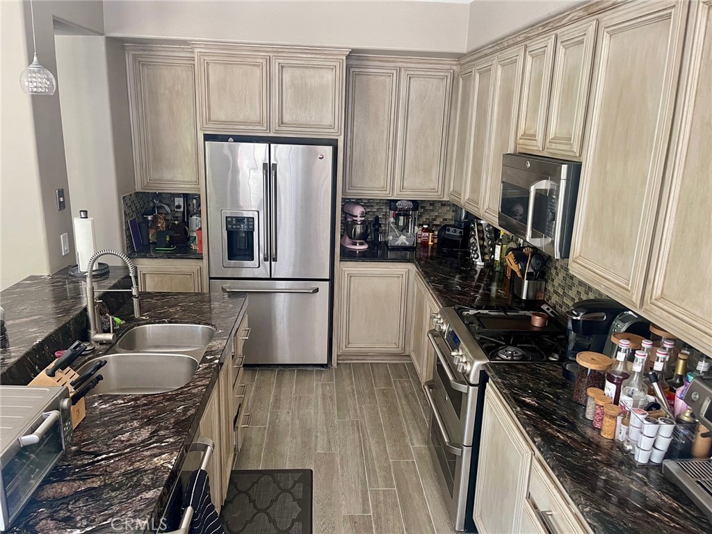 45 Blazewood Lake Forest, CA 92610 - Photo 7 of 13 a kitchen with granite countertop a refrigerator stove and sink