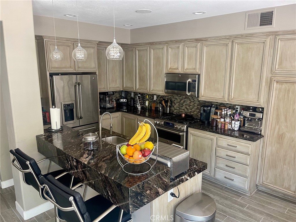 45 Blazewood Lake Forest, CA 92610 - Photo 8 of 13 a kitchen with a wooden cabinets and stove