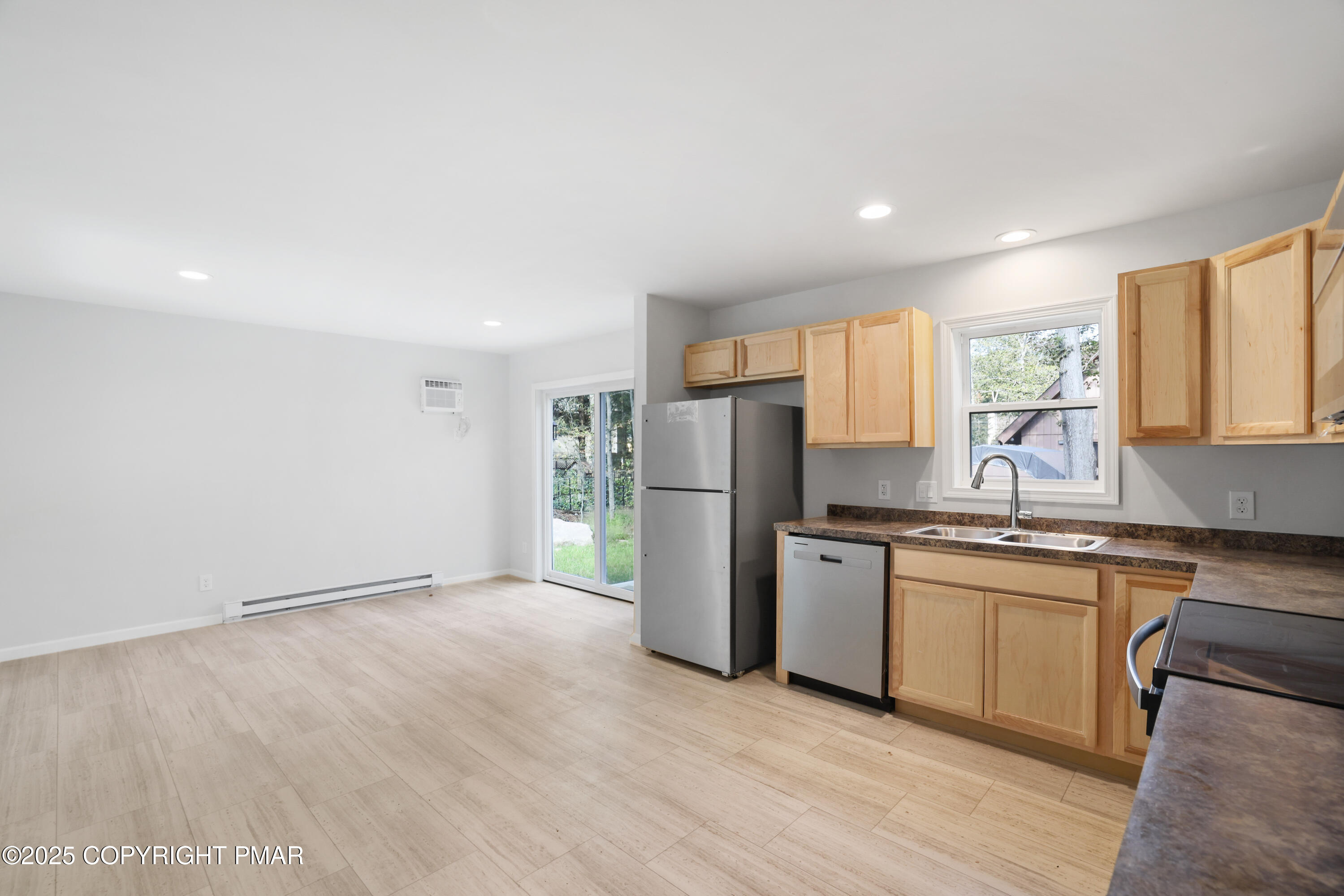 8475 Bumble Bee Way Tobyhanna, PA 18466 - Photo 11 of 28 a kitchen with stainless steel appliances granite countertop a refrigerator a sink dishwasher a stove with wooden cabinets and floor