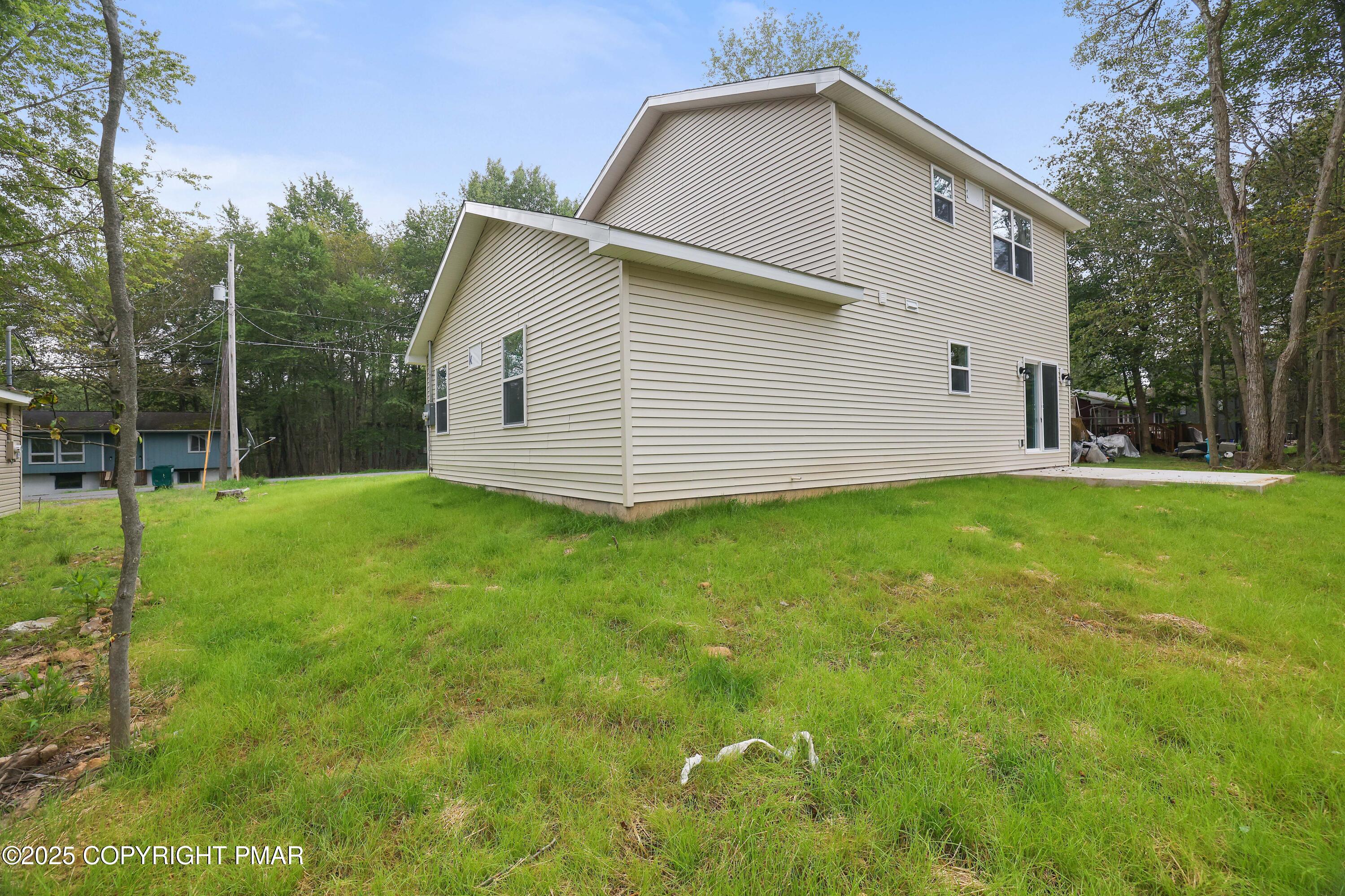 8475 Bumble Bee Way Tobyhanna, PA 18466 - Photo 27 of 28 a backyard of a house with potted plants and large tree