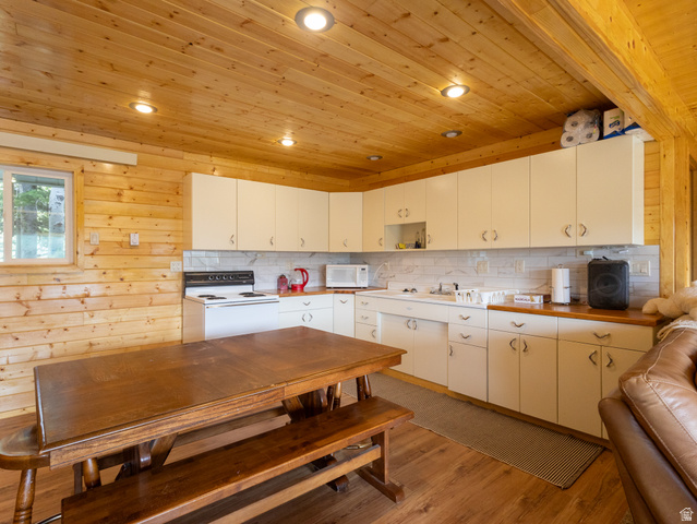 4770 Pine Crest Road Evanston, UT 82930 - Photo 11 of 24 Kitchen area featuring wood paneling throughout, recessed lighting, and wood-finish flooring