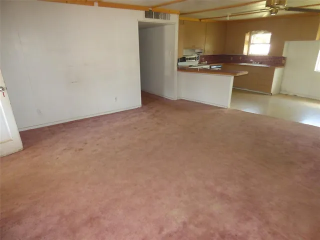 a view of kitchen with refrigerator stove and microwave