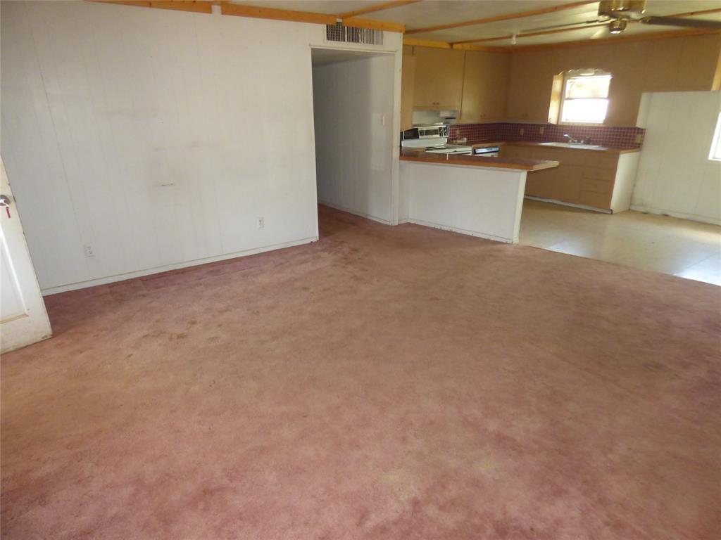 309 East 10th Street Cisco, TX 76437 - Photo 13 of 35 a view of kitchen with refrigerator stove and microwave