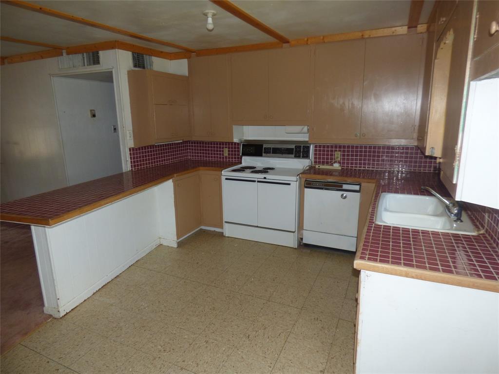 309 East 10th Street Cisco, TX 76437 - Photo 17 of 35 a kitchen with a cabinets and white appliances