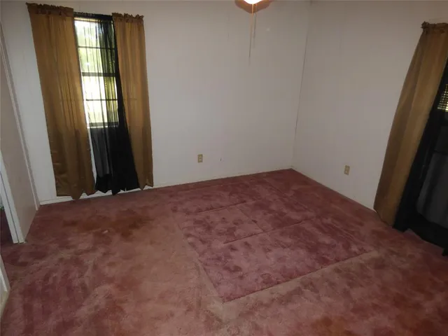 a view of an empty room with closet area