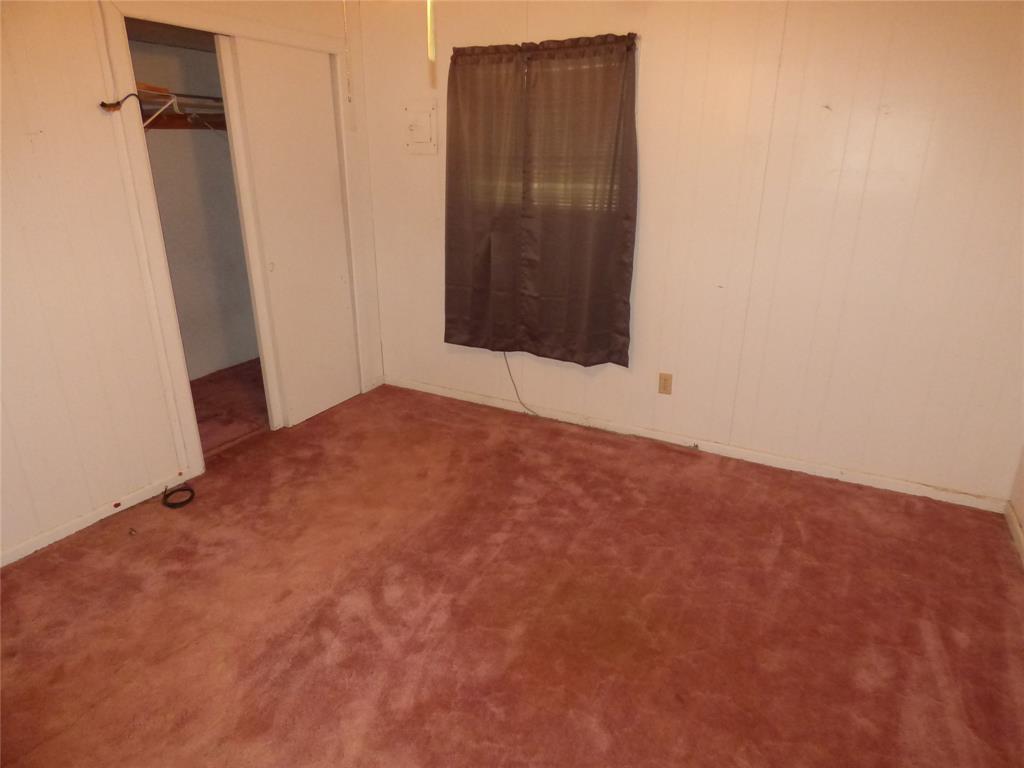 309 East 10th Street Cisco, TX 76437 - Photo 29 of 35 an empty room with wooden floor