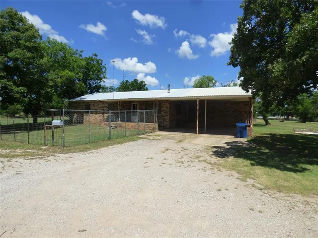 a view of a house with a yard and sitting area