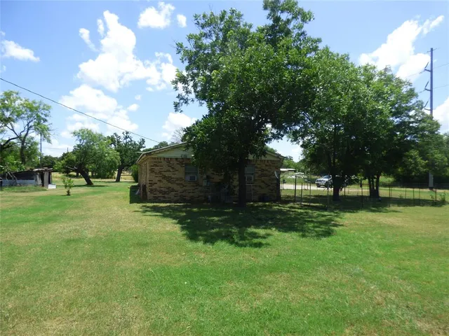 a view of a backyard with large trees