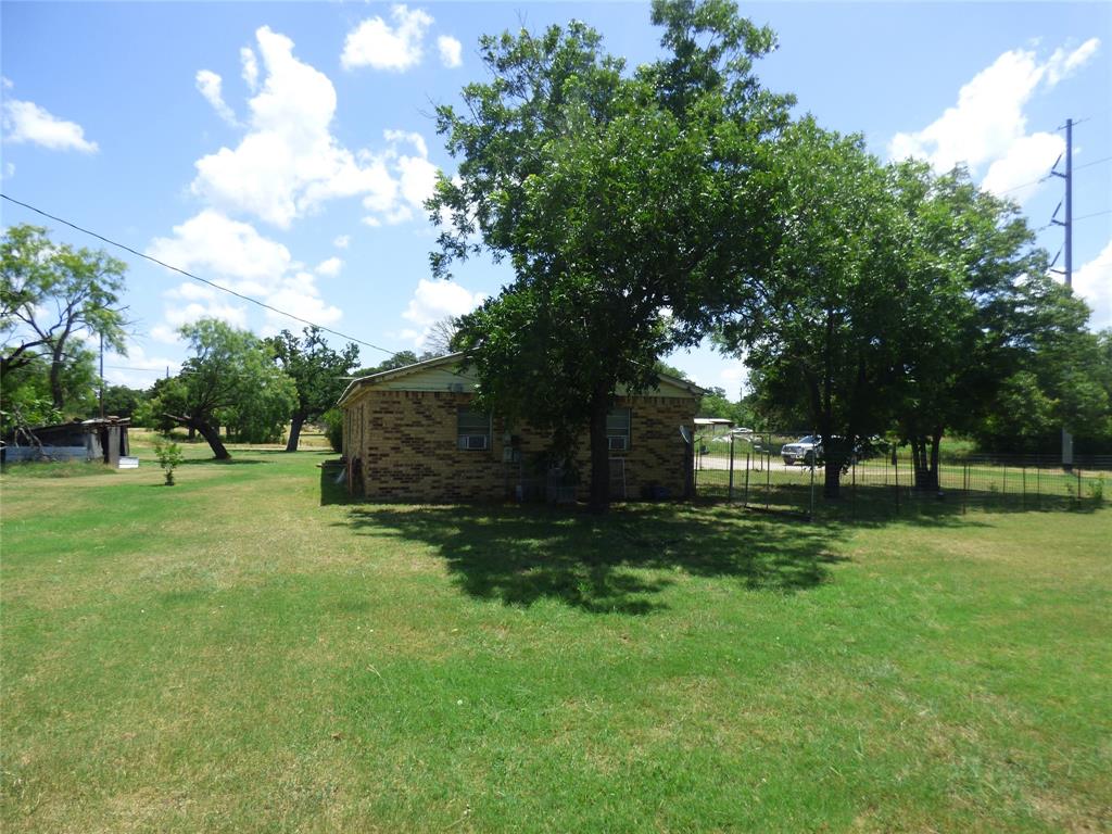 309 East 10th Street Cisco, TX 76437 - Photo 7 of 35 a view of a backyard with large trees