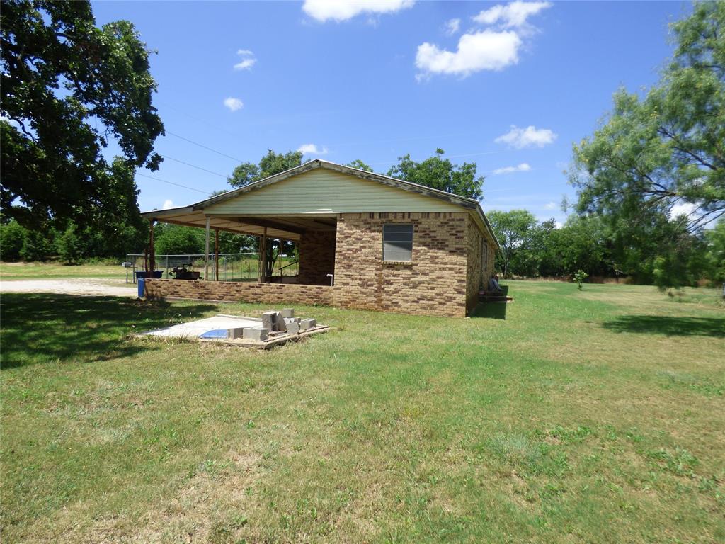 309 East 10th Street Cisco, TX 76437 - Photo 10 of 35 a front view of a house with garden