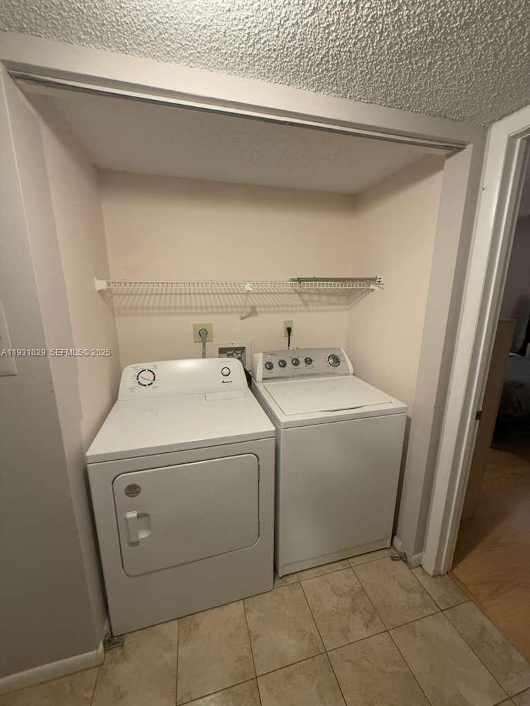 621 Lyons Road, Unit 9201 Coconut Creek, FL 33063 - Photo 11 of 28 a utility room with dryer and washer