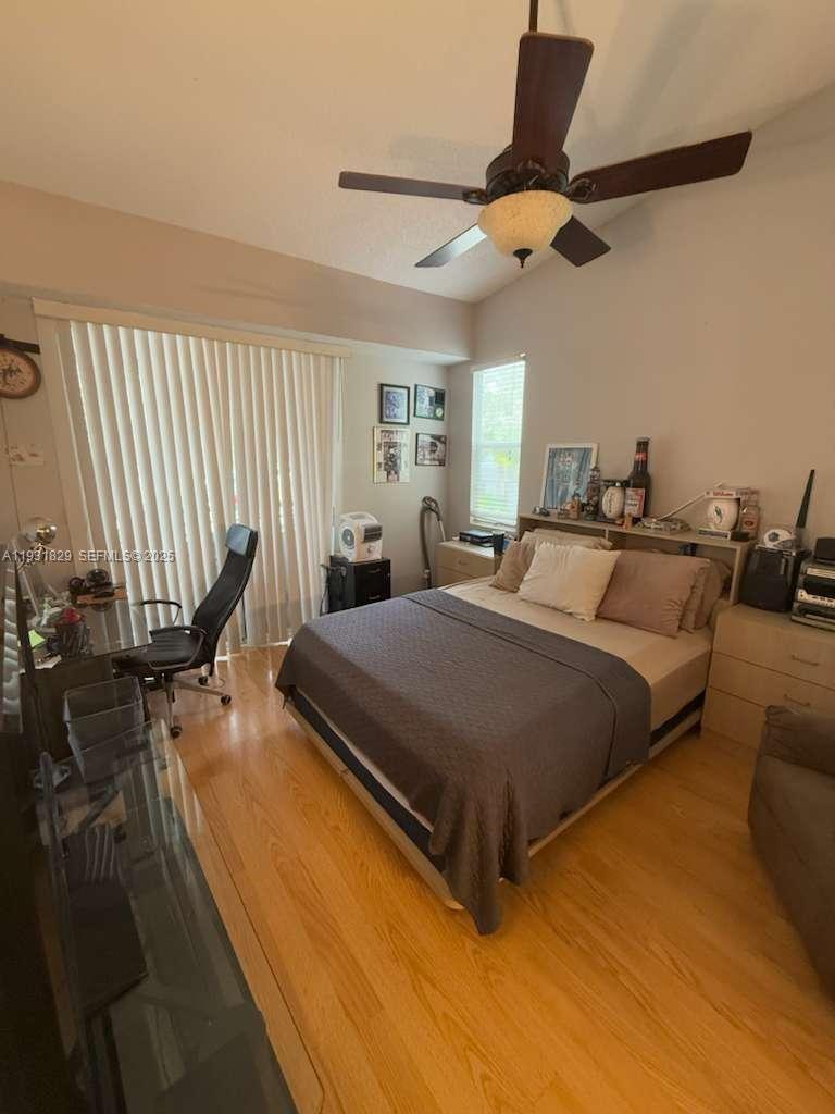 621 Lyons Road, Unit 9201 Coconut Creek, FL 33063 - Photo 12 of 28 a bedroom with a bed and window