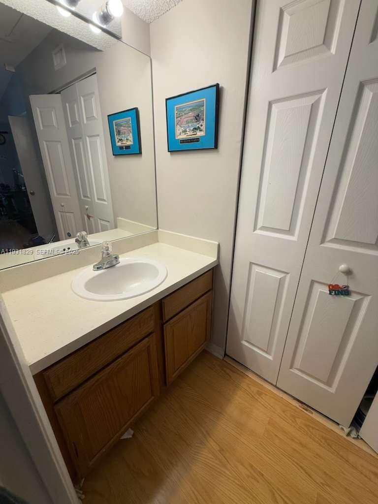 621 Lyons Road, Unit 9201 Coconut Creek, FL 33063 - Photo 14 of 28 a bathroom with a sink mirror and a toilet