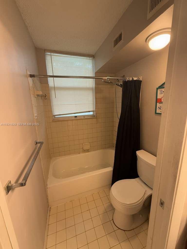621 Lyons Road, Unit 9201 Coconut Creek, FL 33063 - Photo 15 of 28 a bathroom with a toilet and a shower