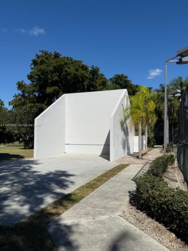 621 Lyons Road, Unit 9201 Coconut Creek, FL 33063 - Photo 23 of 28 a view of a white house with a yard