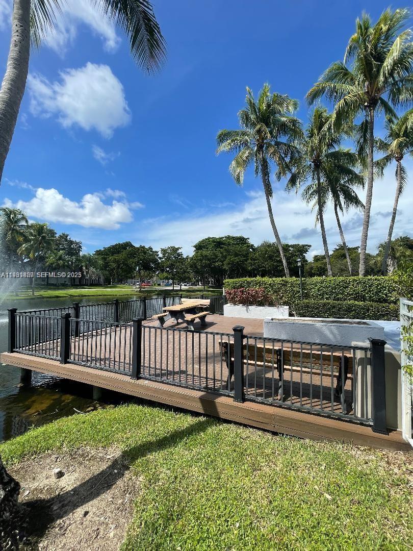 621 Lyons Road, Unit 9201 Coconut Creek, FL 33063 - Photo 26 of 28 a view of a yard with lake view