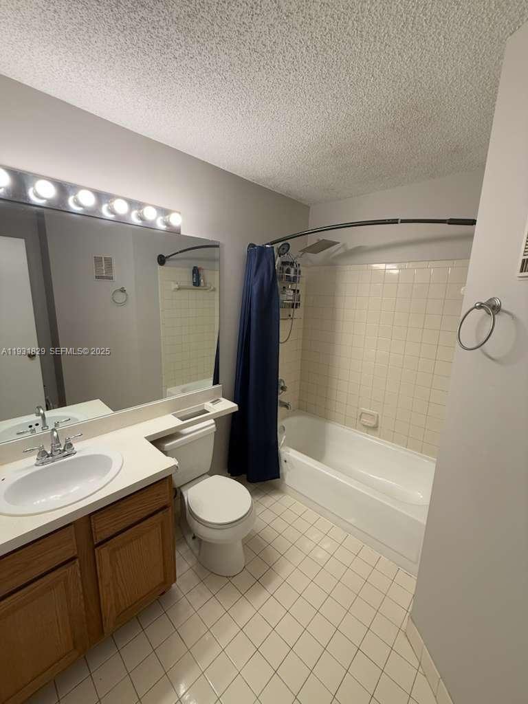 621 Lyons Road, Unit 9201 Coconut Creek, FL 33063 - Photo 8 of 28 a bathroom with a sink toilet and shower
