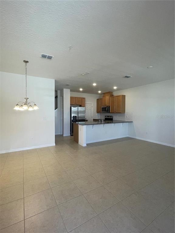 12264 Linear Street Orlando, FL 32832 - Photo 2 of 10 a view of a kitchen with a sink and a microwave
