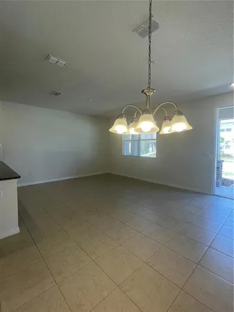 a view of a room with windows and chandelier