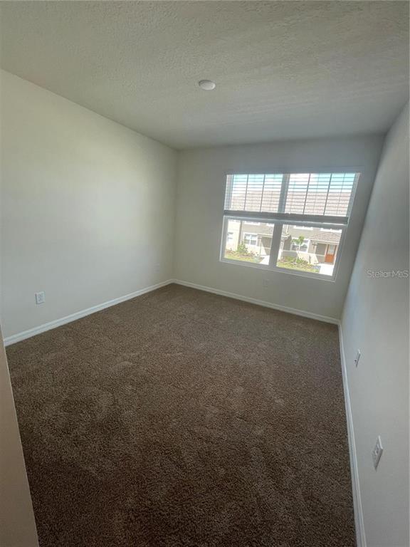 12264 Linear Street Orlando, FL 32832 - Photo 7 of 10 an empty room with a window