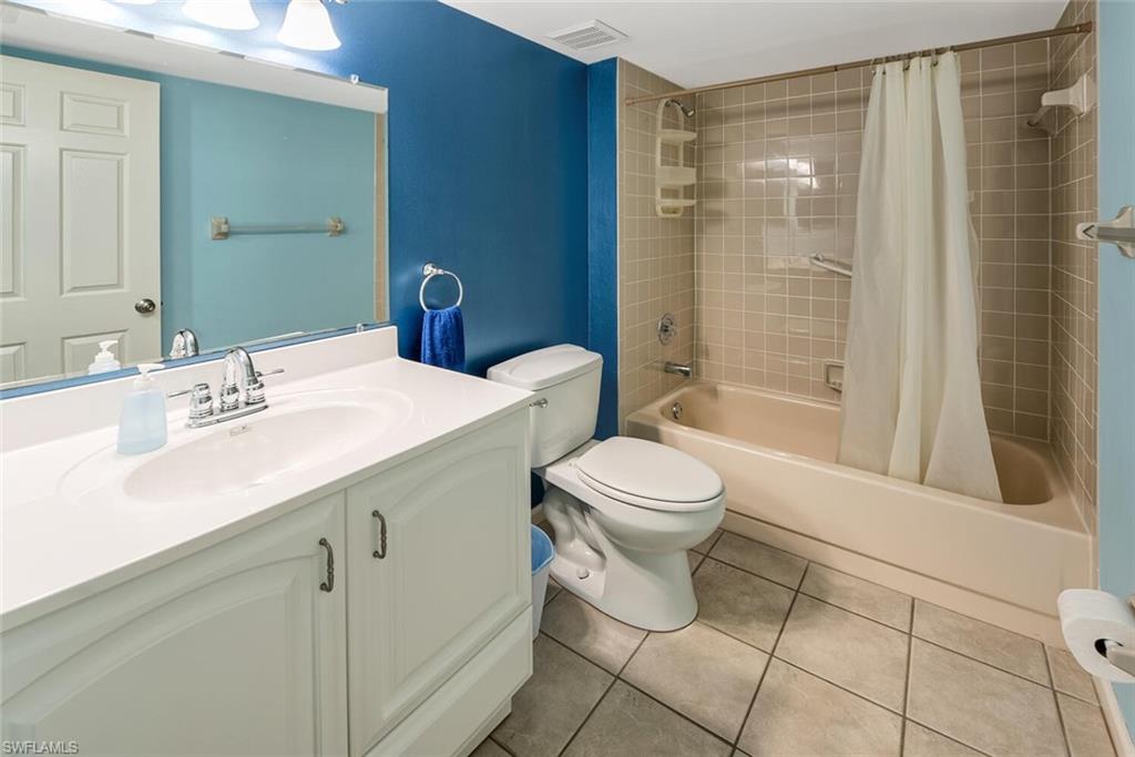 780 Augusta Boulevard, Unit C102 Naples, FL 34113 - Photo 18 of 26 a bathroom with a sink toilet and shower