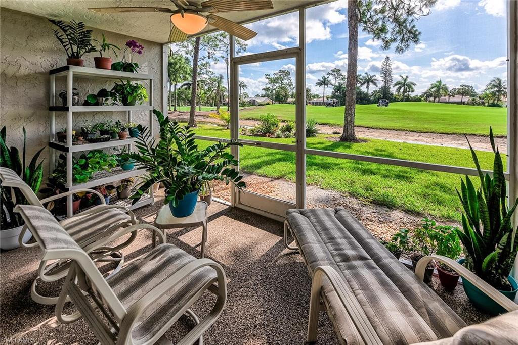 780 Augusta Boulevard, Unit C102 Naples, FL 34113 - Photo 2 of 26 a view of a patio with table and chairs potted plants with wooden floor
