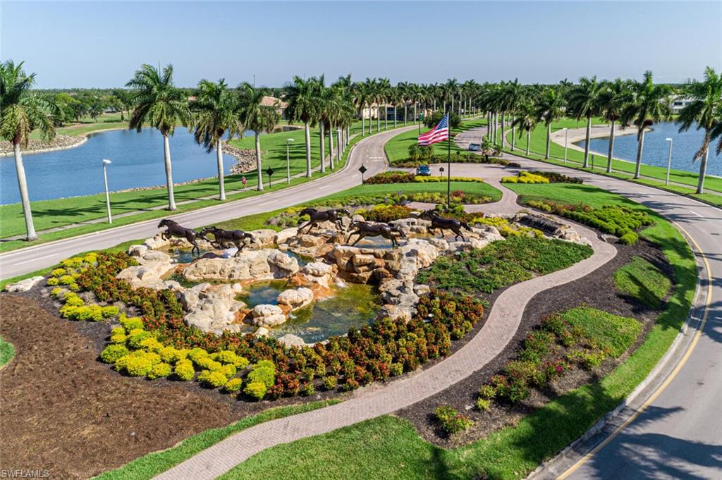 780 Augusta Boulevard, Unit C102 Naples, FL 34113 - Photo 23 of 26 a view of a swimming pool with a garden and plants
