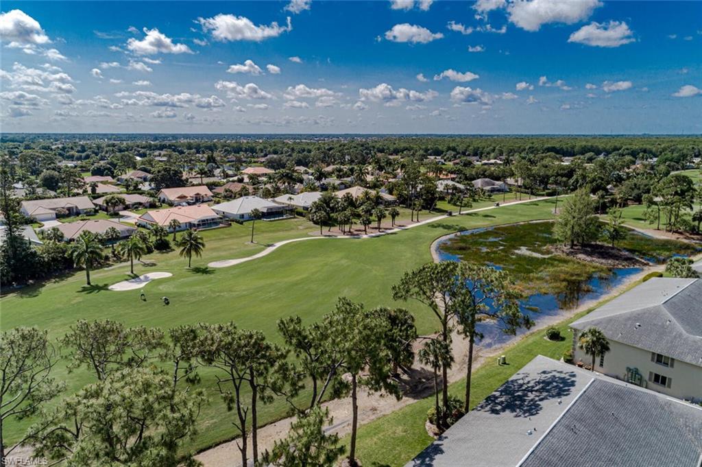 780 Augusta Boulevard, Unit C102 Naples, FL 34113 - Photo 3 of 26 a view of a lake with houses