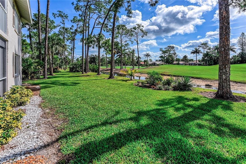 780 Augusta Boulevard, Unit C102 Naples, FL 34113 - Photo 5 of 26 a view of a park with large trees