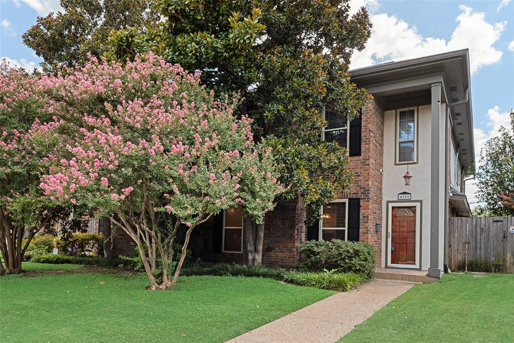 4988 Thunder Road Dallas, TX 75244 - Photo 1 of 32 Brick exterior with contrasting stucco elements and dark window shutters