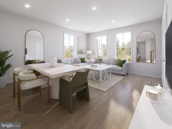 a living room with granite countertop furniture a rug a potted plant and a large window