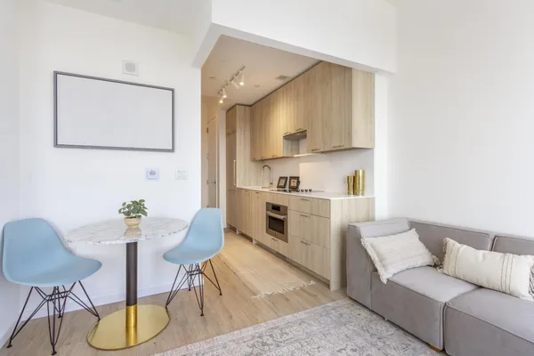 a kitchen with stainless steel appliances kitchen island a table and chair
