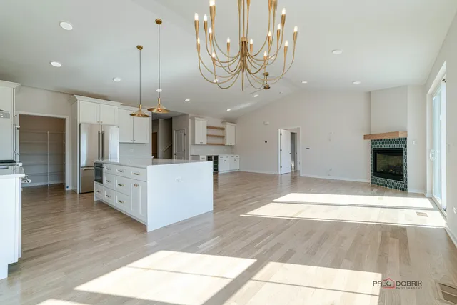 a large kitchen with a table and chairs in it