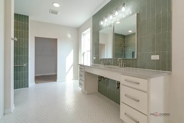 a spacious bathroom with a granite countertop sink a toilet a mirror and a shower
