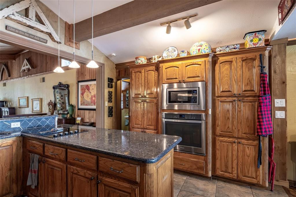 13360 Miller Road Azle, TX 76020 - Photo 12 of 23 a kitchen with refrigerator and cabinets