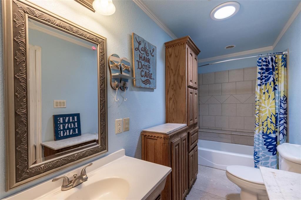 13360 Miller Road Azle, TX 76020 - Photo 19 of 23 a bathroom with a sink a toilet and shower