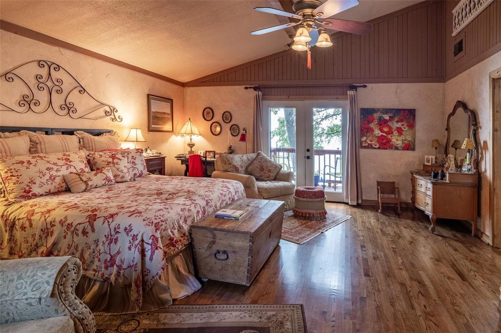 13360 Miller Road Azle, TX 76020 - Photo 10 of 23 a bed room with a bed and a chandelier