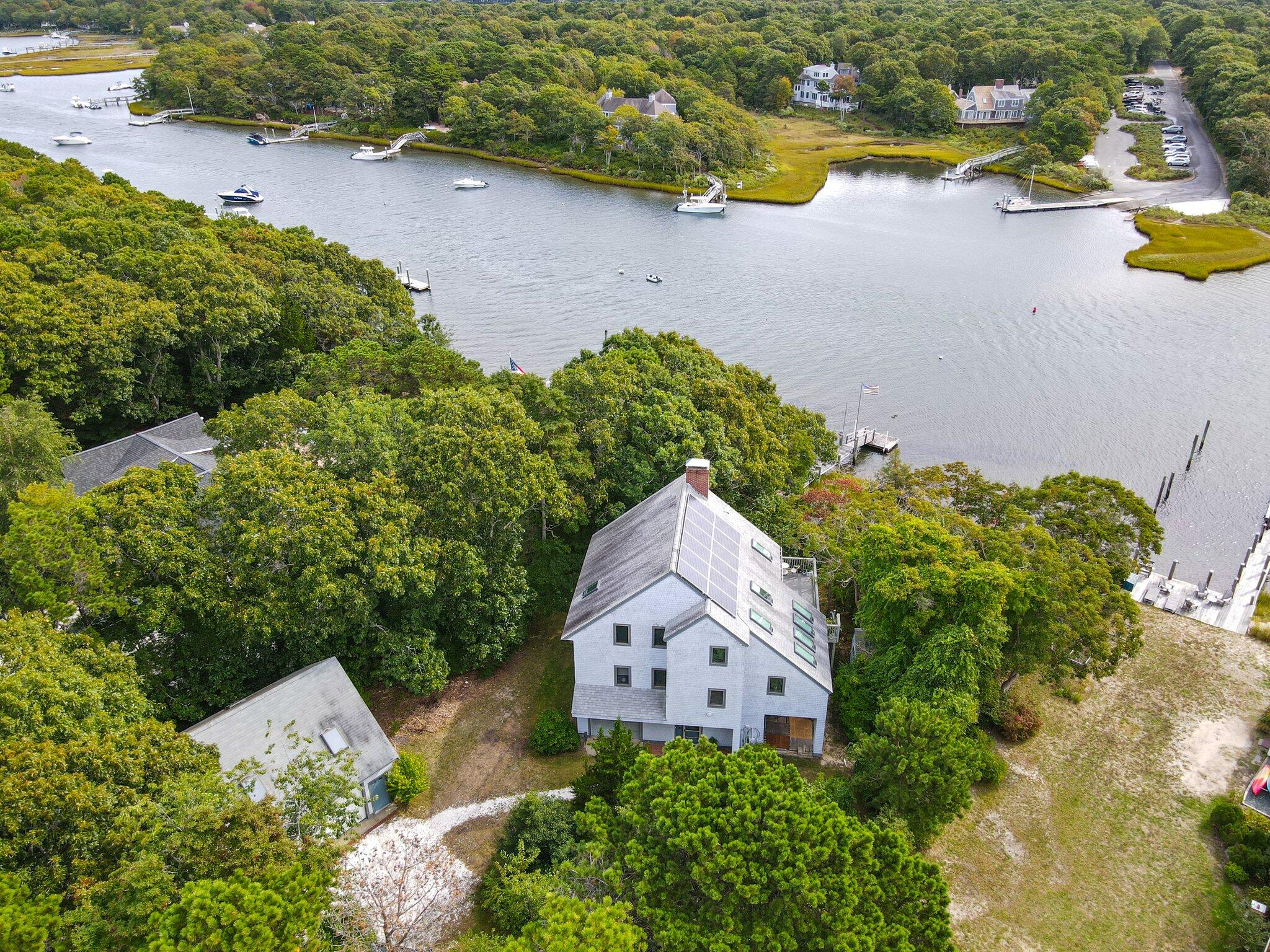 an aerial view of a house with swimming pool and garden