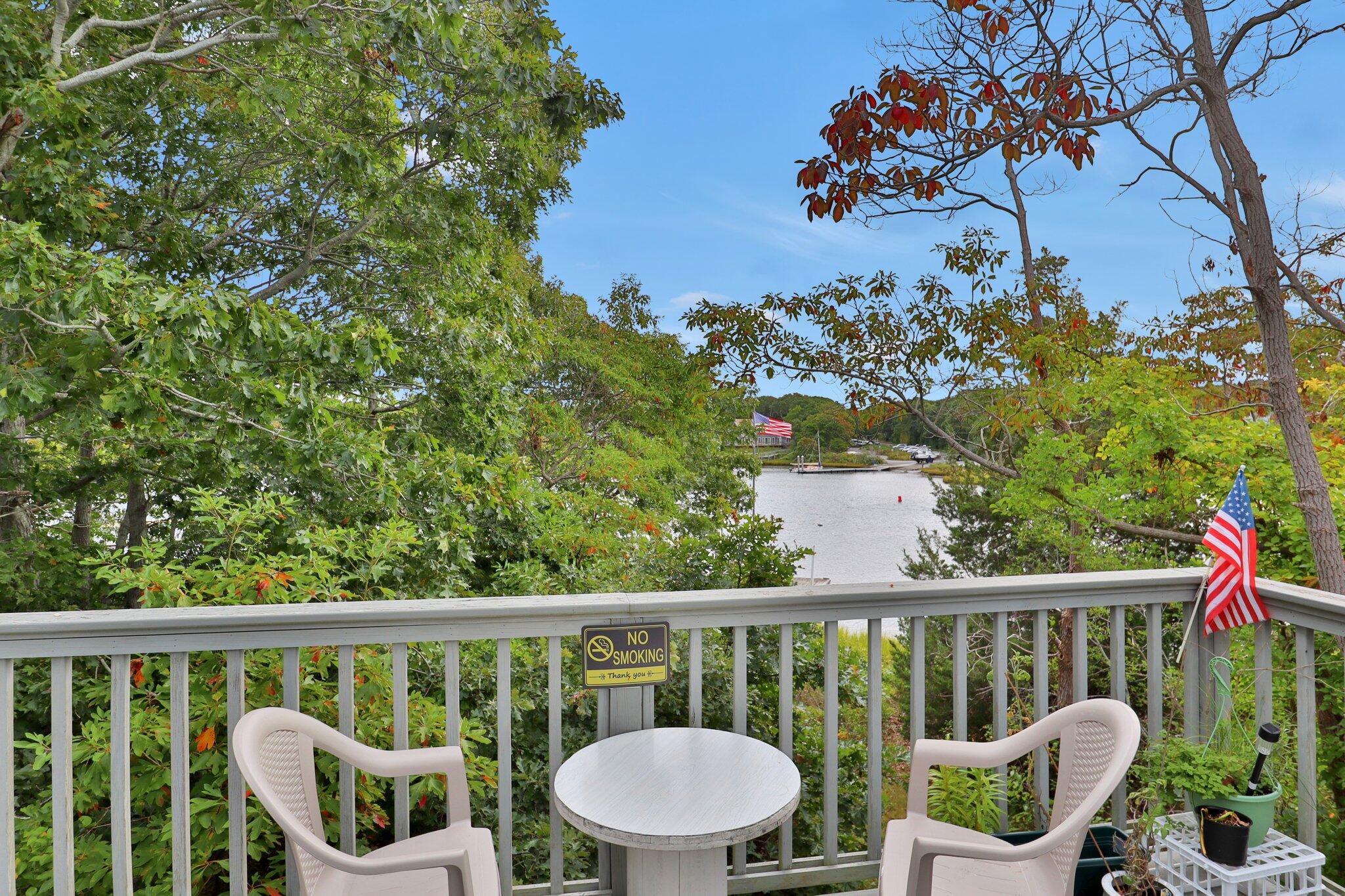 362 Monomoscoy Road Mashpee, MA 02649 - Photo 38 of 48 a view of a chair and table in the balcony