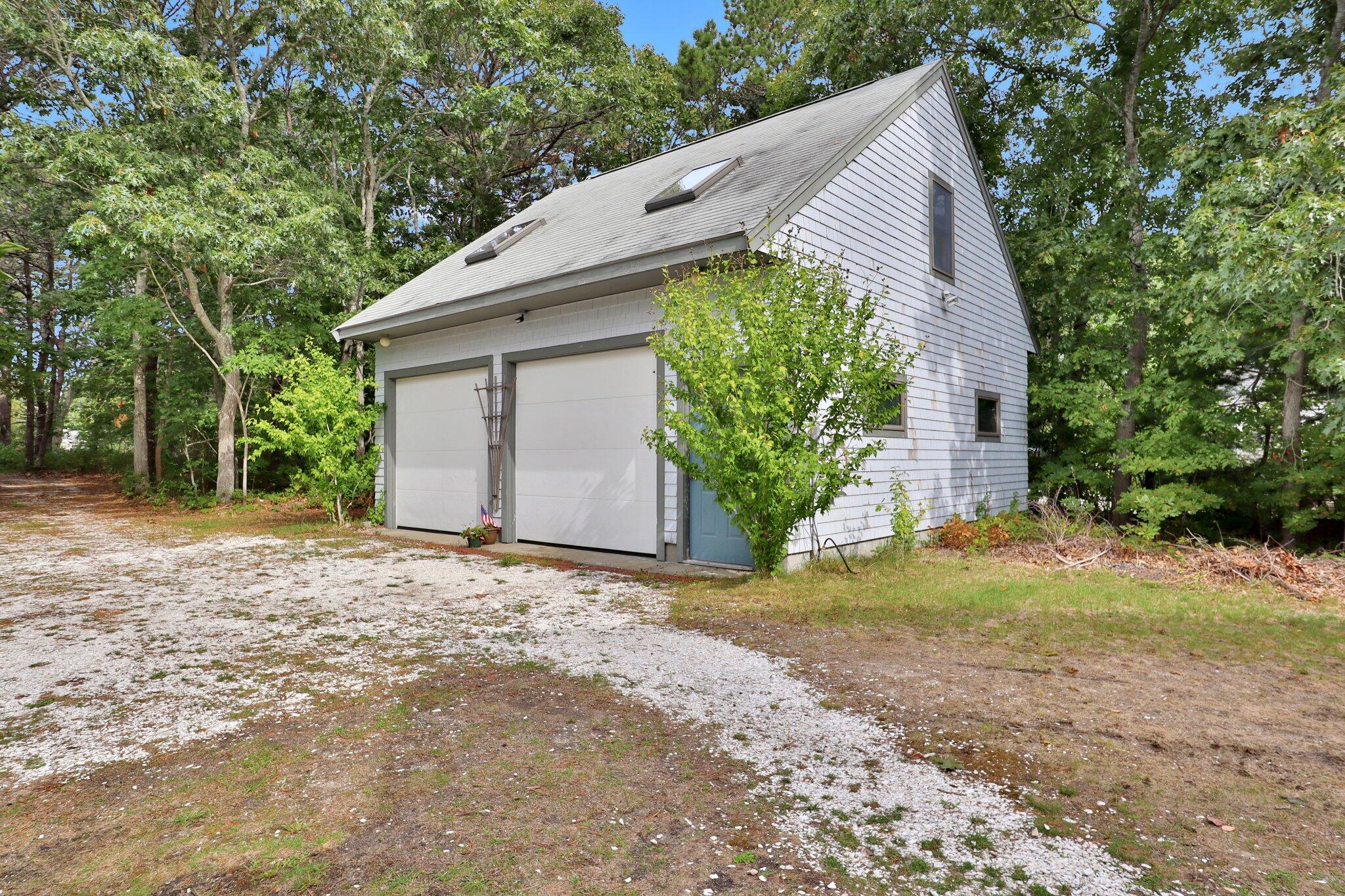 362 Monomoscoy Road Mashpee, MA 02649 - Photo 7 of 48 a backyard of a house with large trees and plants