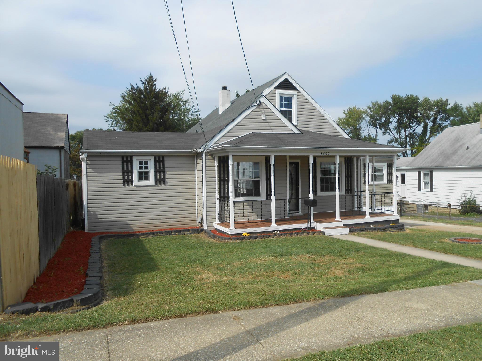 2405 Meadow Road Baltimore, MD 21222 - Photo 2 of 13 a front view of a house with a yard