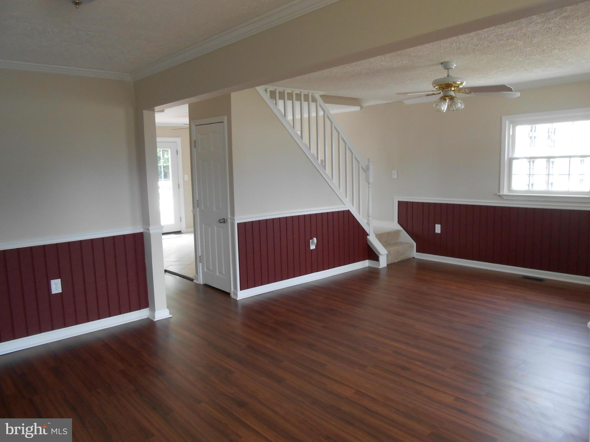 2405 Meadow Road Baltimore, MD 21222 - Photo 6 of 13 a view of an empty room with wooden floor and a window