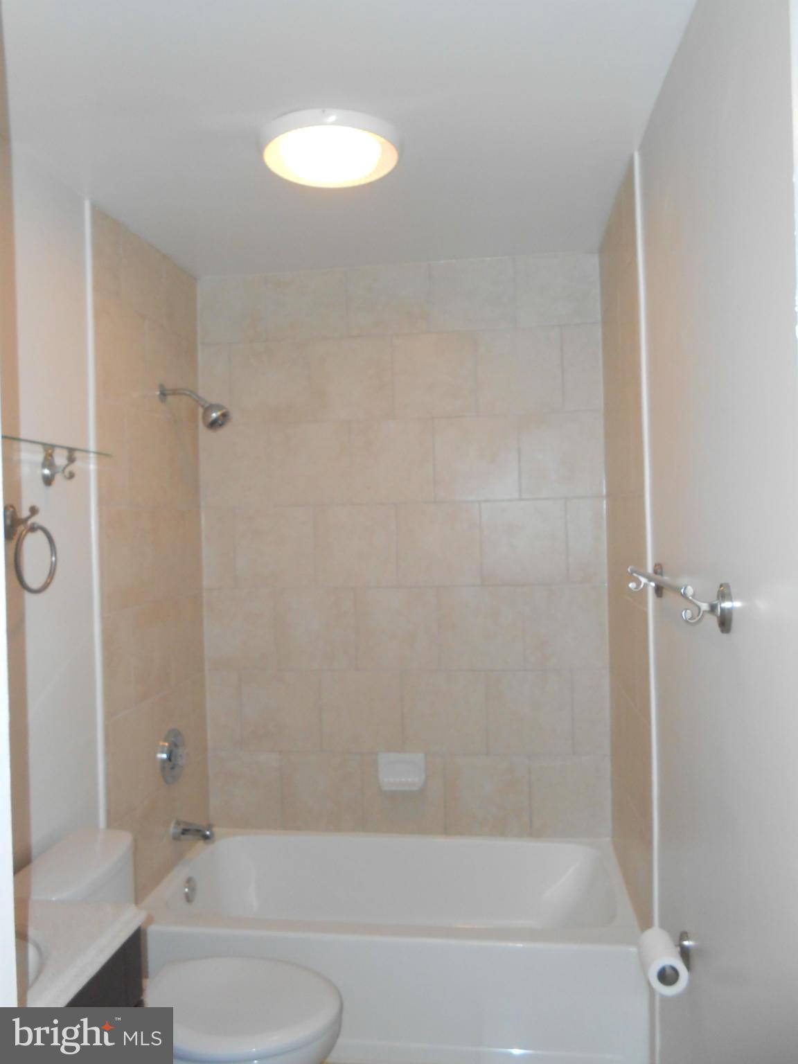 2405 Meadow Road Baltimore, MD 21222 - Photo 8 of 13 a bathroom with a bathtub and a shower