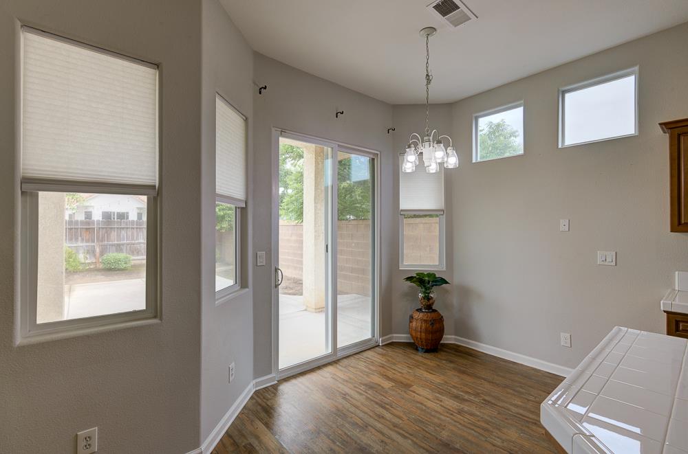 3235 Rall Avenue Clovis, CA 93619 - Photo 27 of 33 a room that has a bed and a chandelier