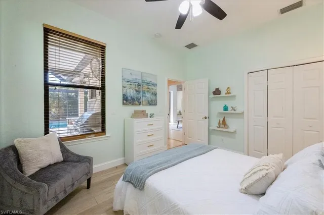 a bedroom with a bed couch and window