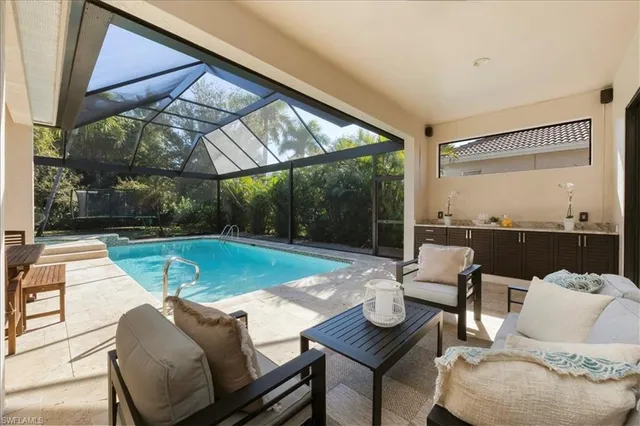 a backyard of a house with barbeque oven table and chairs