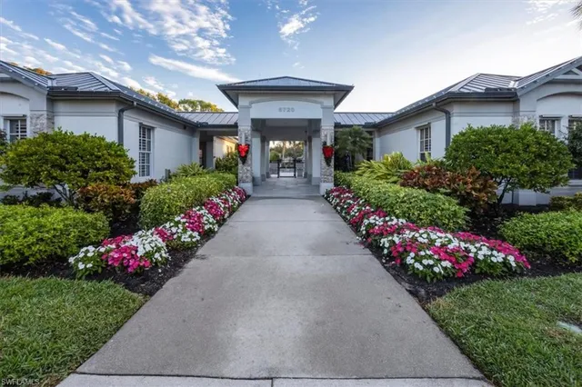 a front view of a house with a yard and flowers